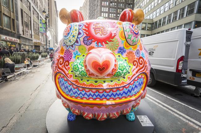 View from front of a large brightly-colored boar sculpture