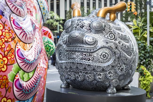 Animal sculpture covered in black & white pattern with golden horns.