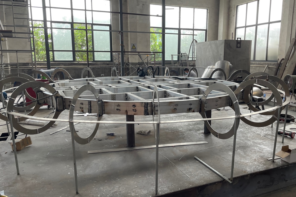 A circular construction of metal piping that will be the inside skeleton of the new button sculpture.