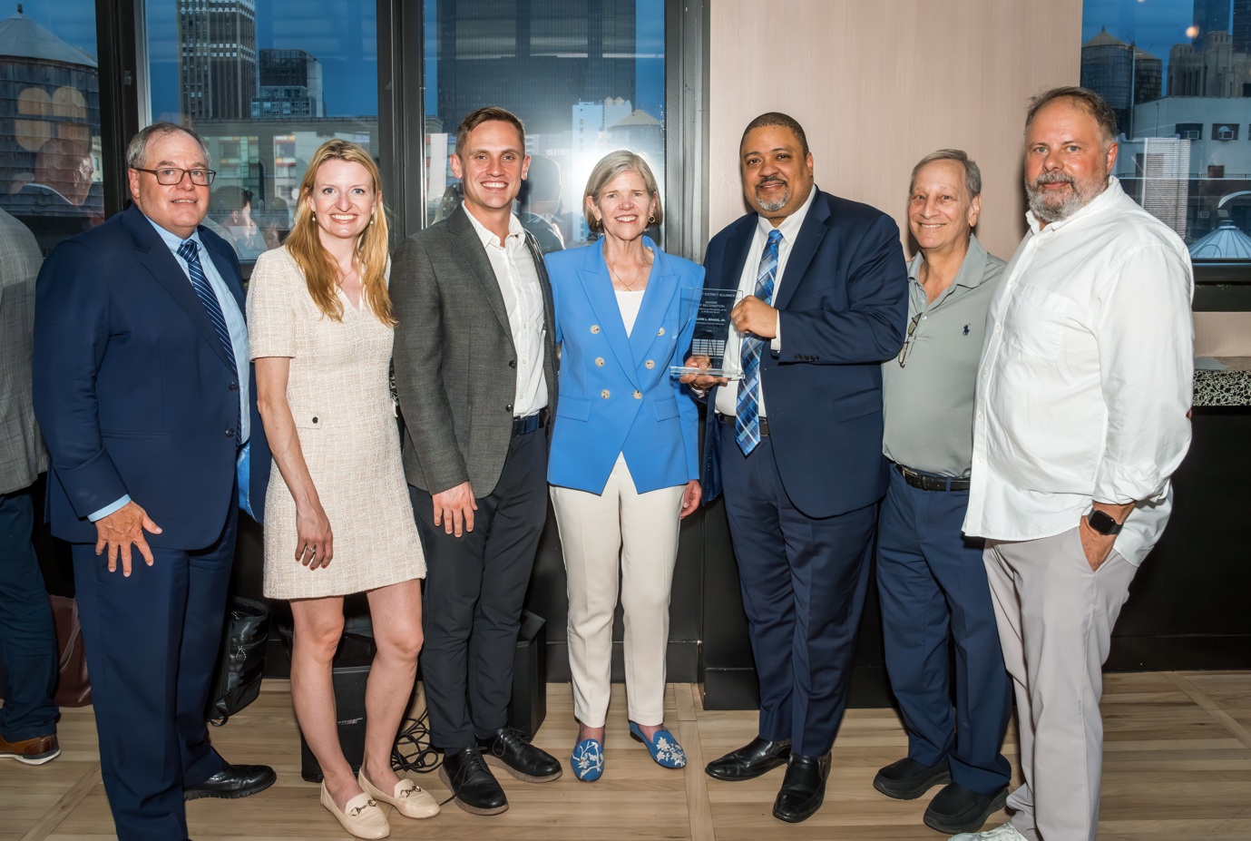 DA Bragg holding his award with President Blair, Council Members Maloney and Wilson, Tom Harris of TSQ Alliance, Board Chair MArty Meyer and Briand Weber