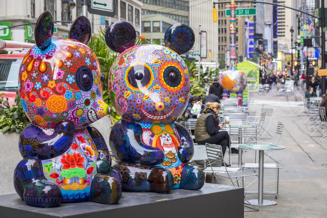 A pair of brightly colored panda sculptures