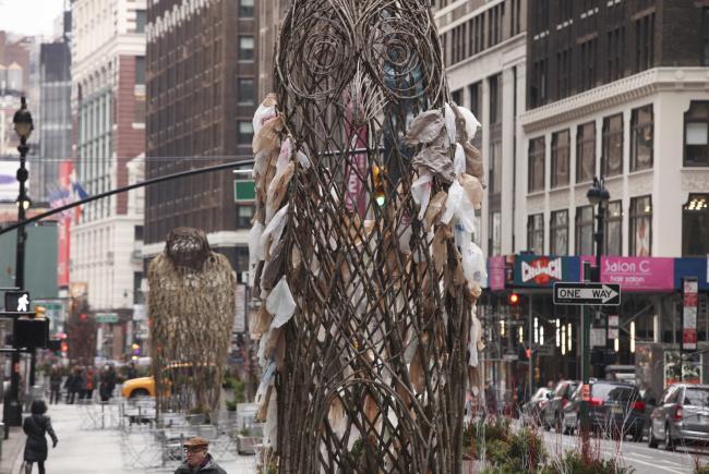 Large sculpture of an owl created from branches