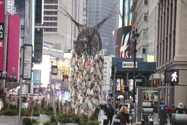 Rear view of large owl sculpture created using natural materials