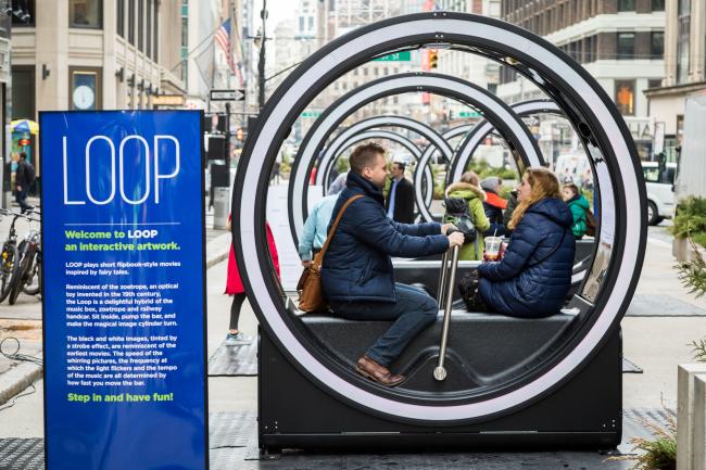 A couple sitting inside a LOOP with more LOOPs in the background