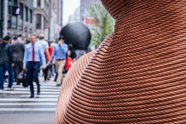 Close up of a section of copper-colored sculpture made from recycled elevator cable