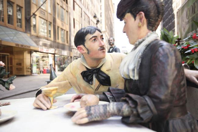 Sculpture of a couple sitting at a table