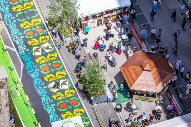 Overhead view of the brightly-colored street mural and plaza beside it.