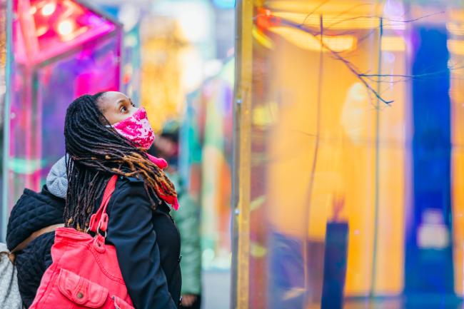 A woman looking up at one of the glass prism sculptures