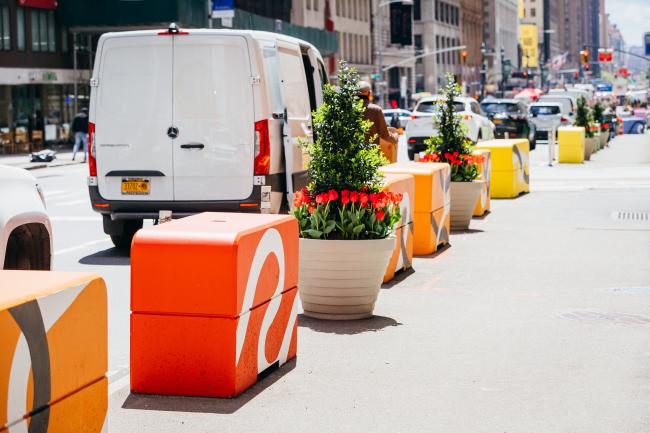 Large blocks in shades of orange and yellow along the edge of the sidewalk.