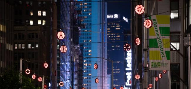 Colorful hanging lanterns with symbols above Broadway in the Garment District