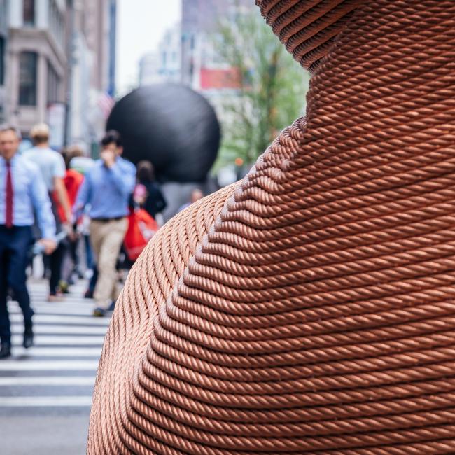 Close up of a section of copper-colored sculpture made from recycled elevator cable