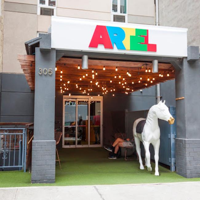 The front of the Artel Hotel, including a white horse statue