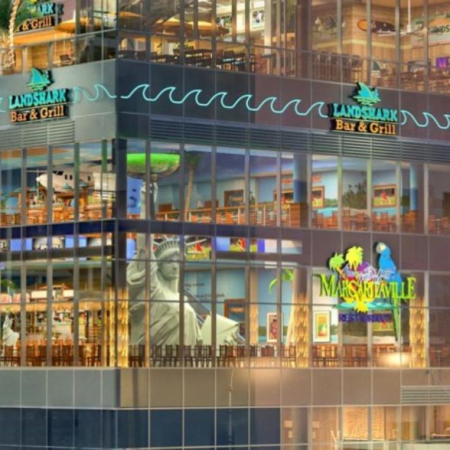 The colorful and brightly lit exterior of the Margaritaville hotel. 