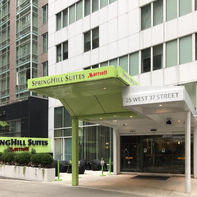 The green and white entrance to the Springhill Suites