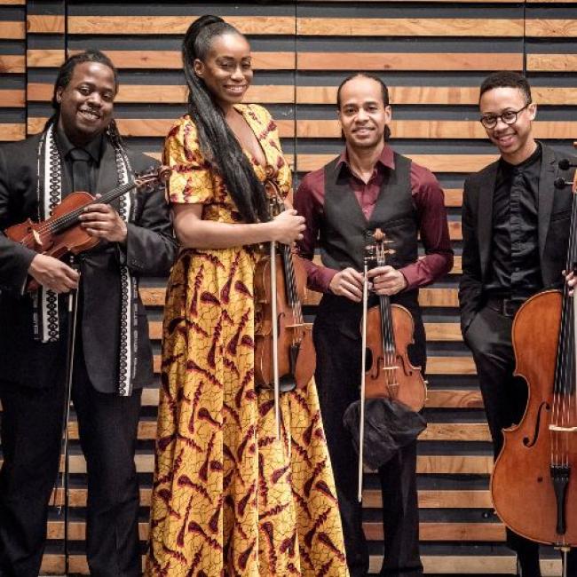 Four musicians holding classical instruments.