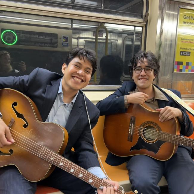 Cupid's nemesis with guitars sitting on a subway. 